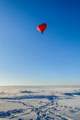 Fototapeta premium Balloon in the form of heart in the sky winter day