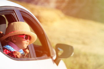 cute little girl travel by car in mountains