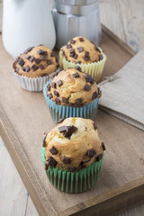 Muffins with chocolate on a wooden table