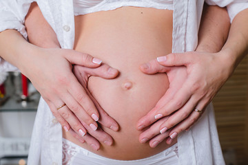 Fototapeta na wymiar pregnant woman and hands