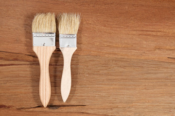 Paint brush on a wooden background.