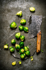 Brussels sprouts with a hatchet. On stone background.