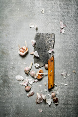 Fragrant cloves of garlic and a large hatchet.