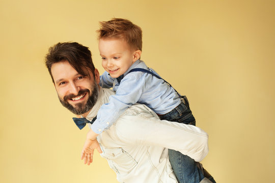 Little boy enjoying with riding on father&rsquo;s back