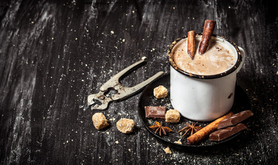 Hot chocolate with cinnamon and cutters for sugar.