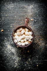 Hot chocolate with marshmallows. On black chalkboard.