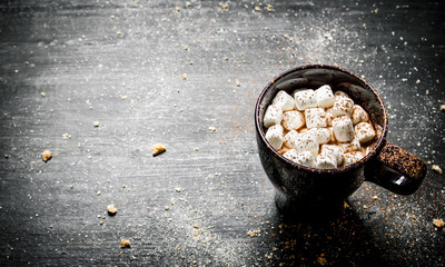 Hot chocolate with marshmallows. On black chalkboard.