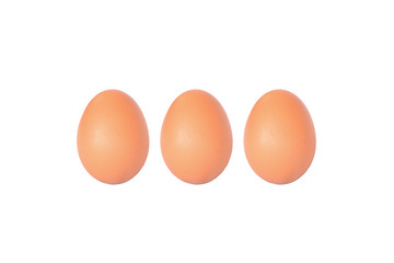 Three brown chicken egg on white fabric background with copy spa