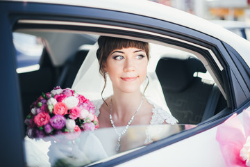 close-up portrait of a bride in car window