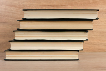 Stack of books on wooden background