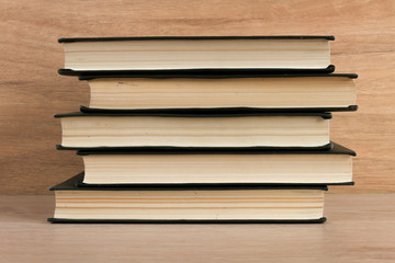 Stack of books on wooden background