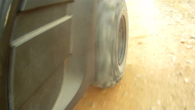 Close up of an all terrain vehicle wheel while trail riding