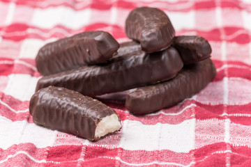 Bunch of chocolate bananas on the kitchen tablecloth