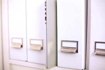 Many papers orderly arranged in a file shelves. And some are still on the table