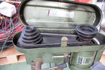 Belt and pulley on the motor round commuting bench drill.