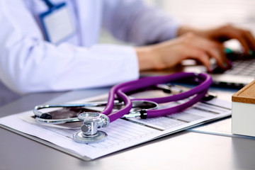 Young doctor at the table is receiving patient