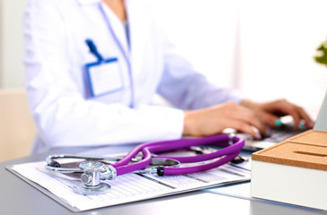 Young doctor at the table is receiving patient