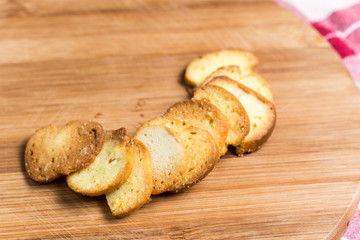 Saulty crispy little toast breads on the wooden board