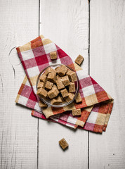 Brown sugar in a Cup on the napkin.