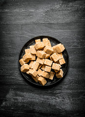 Brown cane sugar in a pan.