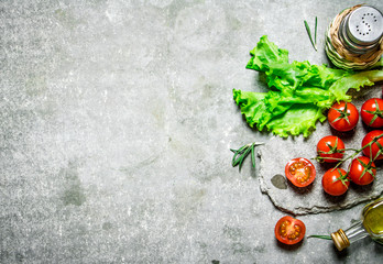 Naklejka na ściany i meble Fresh tomatoes with lettuce and olive oil.