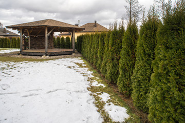 Wooden alcove. Old style. Green fence.