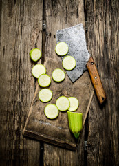 Sliced zucchini and an old hatchet .