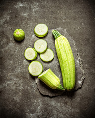 Sliced zucchini on a stone stand.