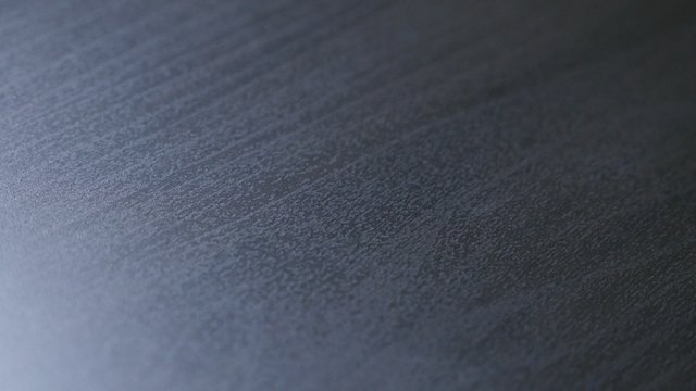 Modern table dark oak wood grain texture close-up 4K 2160p 30fps UHD slow tilting footage - Dark wooden plank surface closeup texture 4K 3840X2160 UHD tilting video 