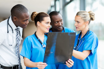 group of medical workers discussing patient's x-ray