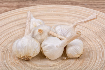 Garlic on a wooden bowl