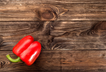 Red paprika on rustic wooden background.