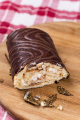 Sliced chocolate roll cake on the wooden board