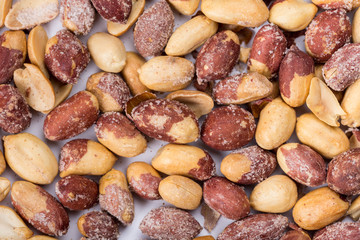 Top macro view of roasted pile of peanuts