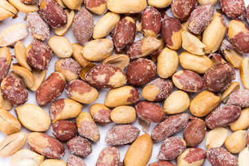Top macro view of roasted pile of peanuts