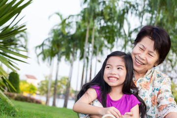 Happy asian grandma and grandchild smiling