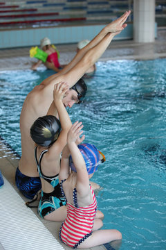little girls at swimming lesson in indoor swimming pool