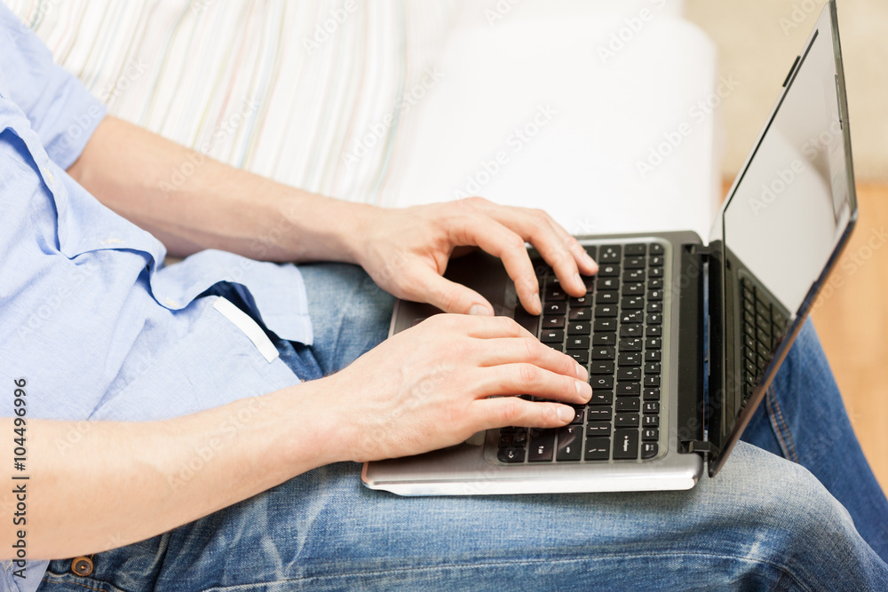 Sticker close up of man typing on laptop computer at home