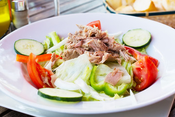 Tuna salad on porcelain plate.