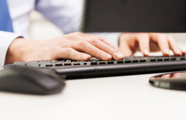 close up of businessman hands typing on keyboard