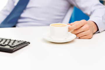 close up of businessman hand with coffee cup
