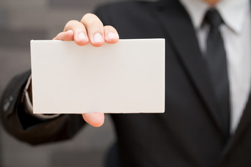 Fototapeta premium Hand of businessman showing white paper