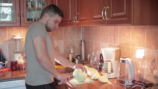 man cutting cabbage