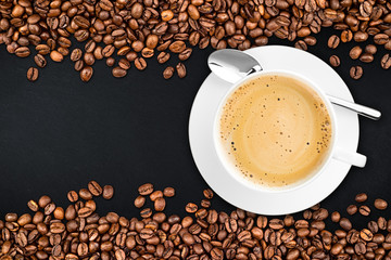 coffee background with beans and cup on slate stone