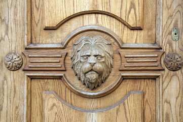 Lion fragment of an ancient carved door closeup