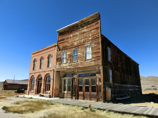 Old vintage abandoned weathered buildings in Bodie, California - landscape color photo
