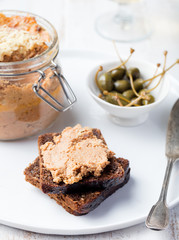 Baked meat pate in jar and on bread Gourmet food