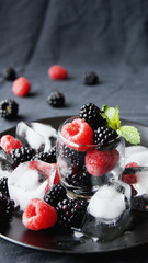 black berries and raspberries in a glass cup