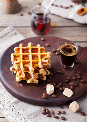 Whole wheat waffles with maple syrup and coffee 