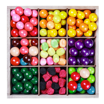 assortment of candy and gum in a wooden box
